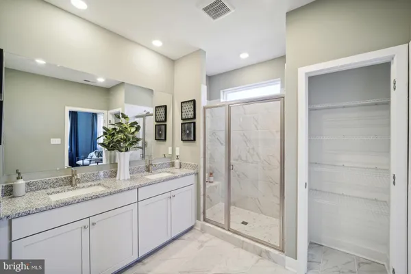 a bathroom with a granite countertop sink mirror and shower