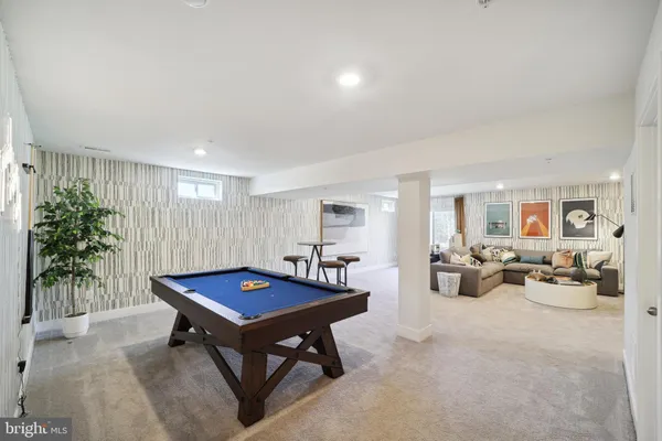 a living room with furniture and potted plants