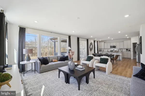 a living room with lots of furniture and a table