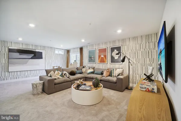 a living room with furniture wooden floor and a flat screen tv
