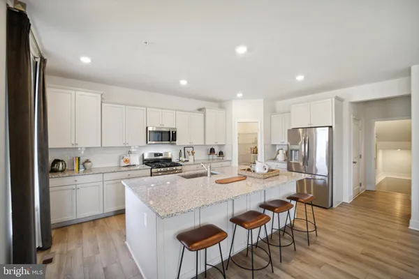 a kitchen with refrigerator and cabinets