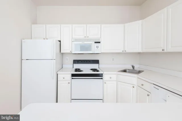 an empty room with windows and cabinet