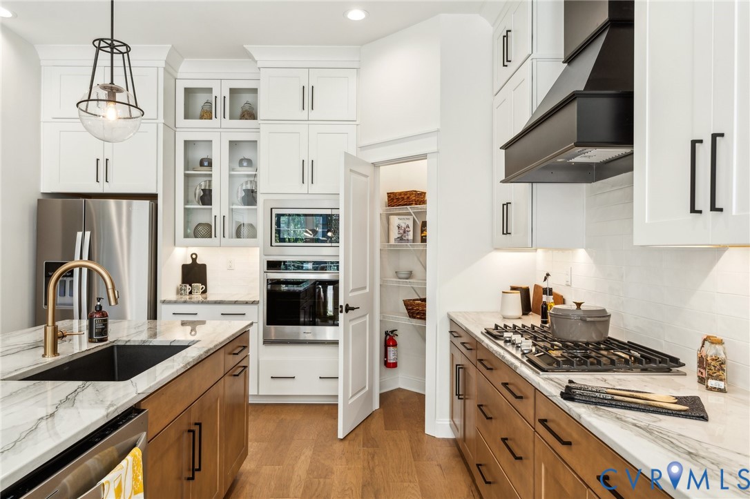 3936 Robins Ridge Drive Moseley, VA 23120 - Photo 6 of 24 a kitchen with stainless steel appliances granite countertop a stove and a sink