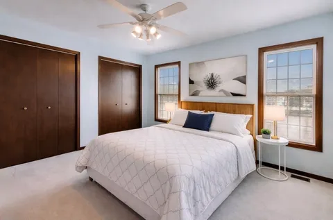 a bedroom with a large bed and a window