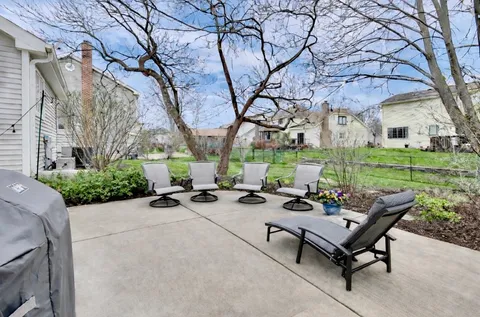 a view of a backyard with sitting area and garden