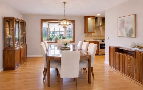 a view of a dining room with furniture window and wooden floor