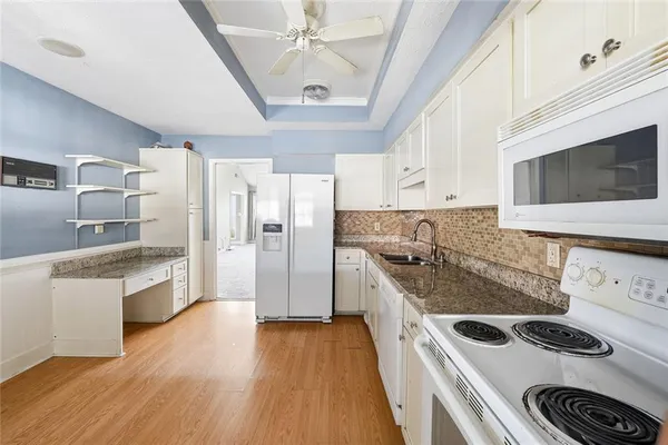 a kitchen with stainless steel appliances granite countertop a stove and a refrigerator