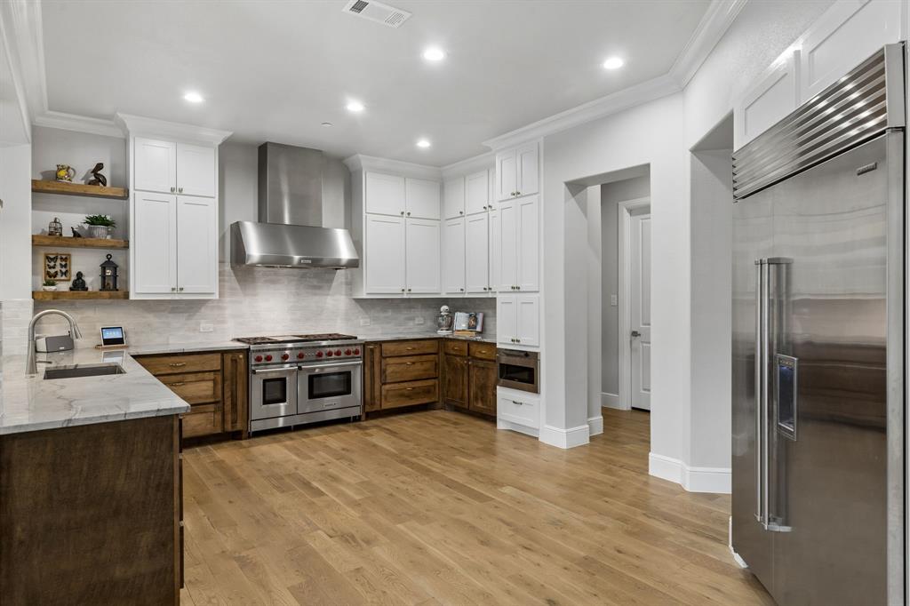 6700 Herbert Road Colleyville, TX 76034 - Photo 15 of 32 a large kitchen with stainless steel appliances granite countertop a stove a sink and a refrigerator