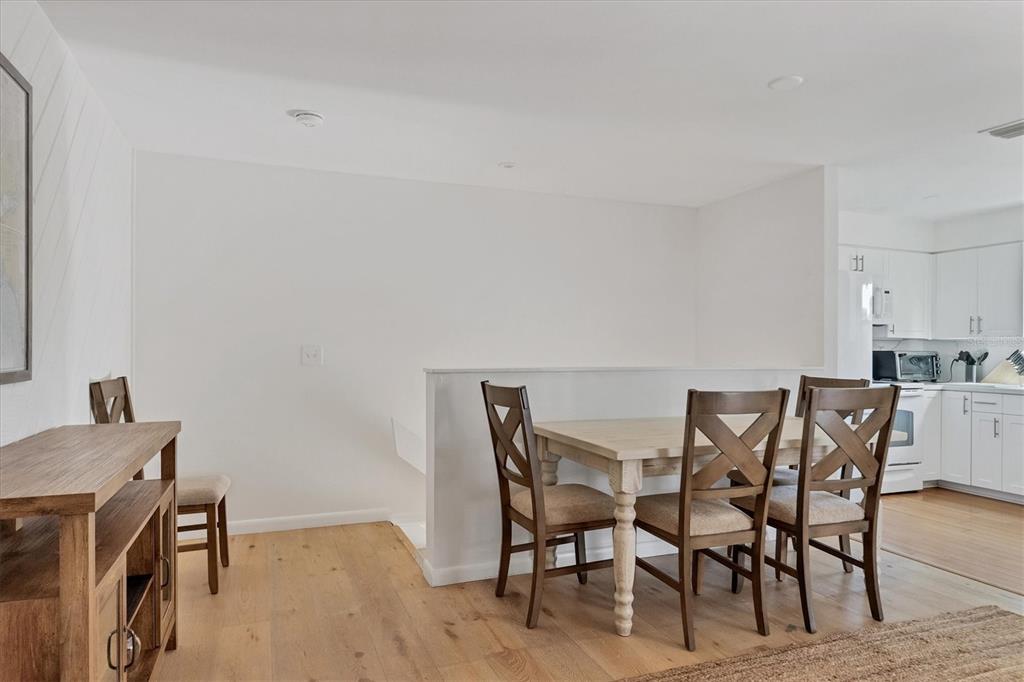 261 Lee Avenue Boca Grande, FL 33921 - Photo 12 of 48 a view of a dining room with furniture and wooden floor