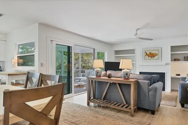 a living room with furniture a flat screen tv and a large window
