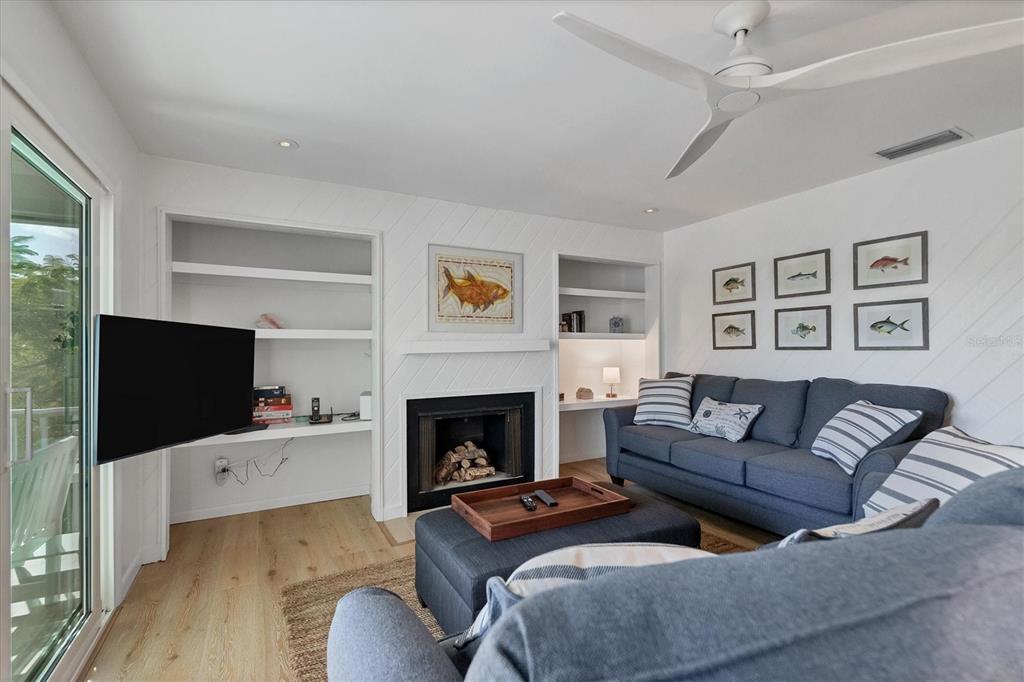 261 Lee Avenue Boca Grande, FL 33921 - Photo 15 of 48 a living room with furniture flat screen tv and a fireplace