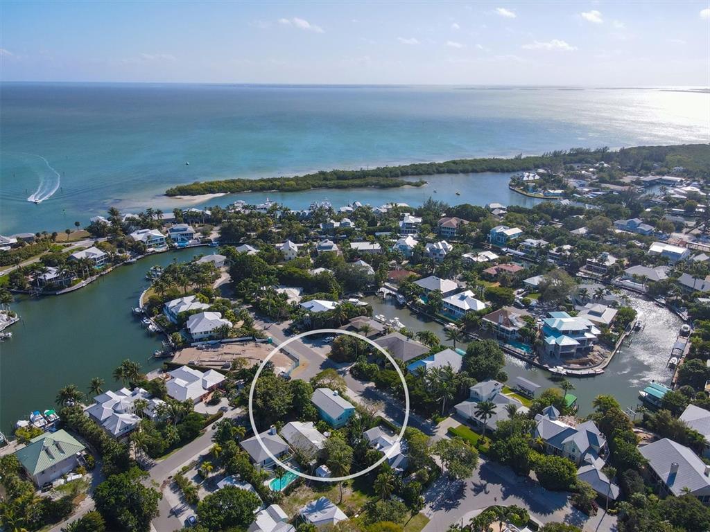 261 Lee Avenue Boca Grande, FL 33921 - Photo 2 of 48 an aerial view of a city with lots of residential buildings and ocean view in back