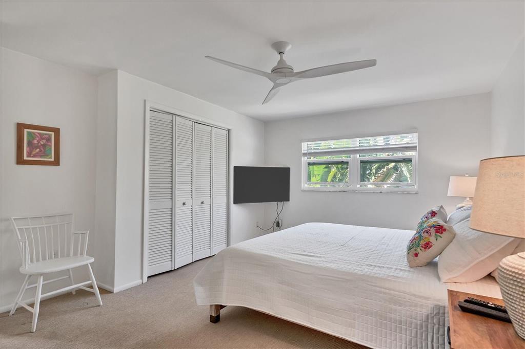 261 Lee Avenue Boca Grande, FL 33921 - Photo 22 of 48 a bedroom with a bed and a chair