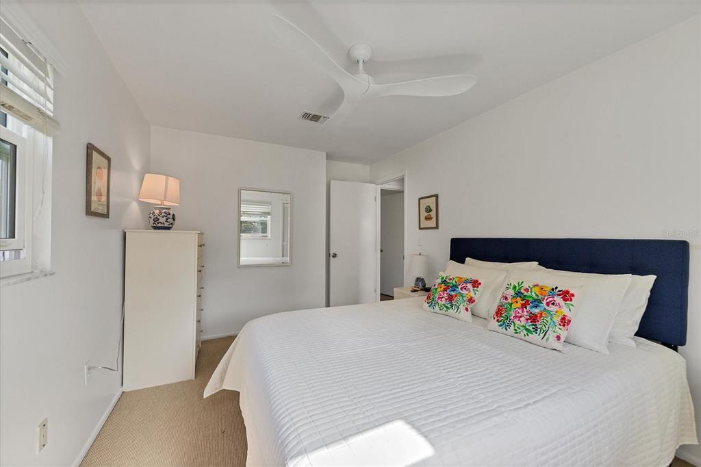 261 Lee Avenue Boca Grande, FL 33921 - Photo 25 of 48 a bedroom with a bed and a cabinets