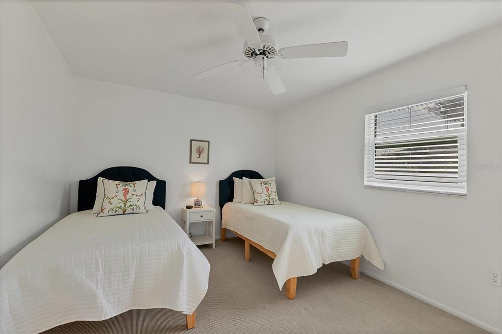 261 Lee Avenue Boca Grande, FL 33921 - Photo 26 of 48 a bedroom with two beds and a window