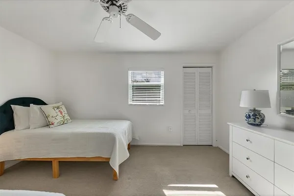 a bedroom with a bed and ceiling fan