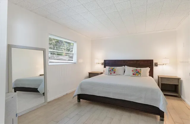 a bedroom with a bed and a mirror