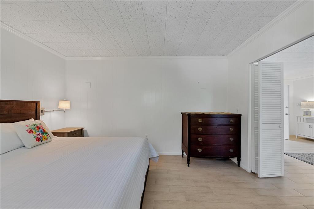 261 Lee Avenue Boca Grande, FL 33921 - Photo 30 of 48 a bedroom with a bed and a cabinets