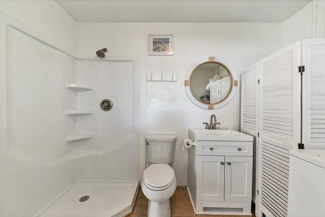 a bathroom with a toilet a sink and a shower