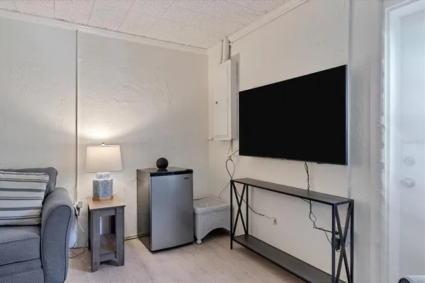 a living room with furniture and a flat screen tv