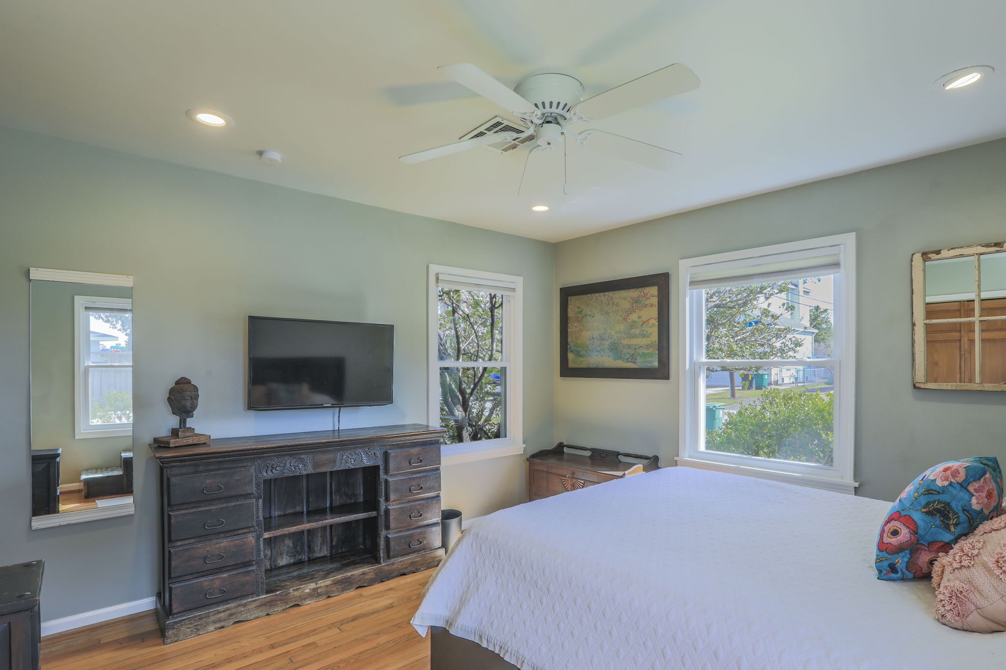 1111 Woodhill Road Houston, TX 77008 - Photo 13 of 42 a bedroom with a bed and wooden floor