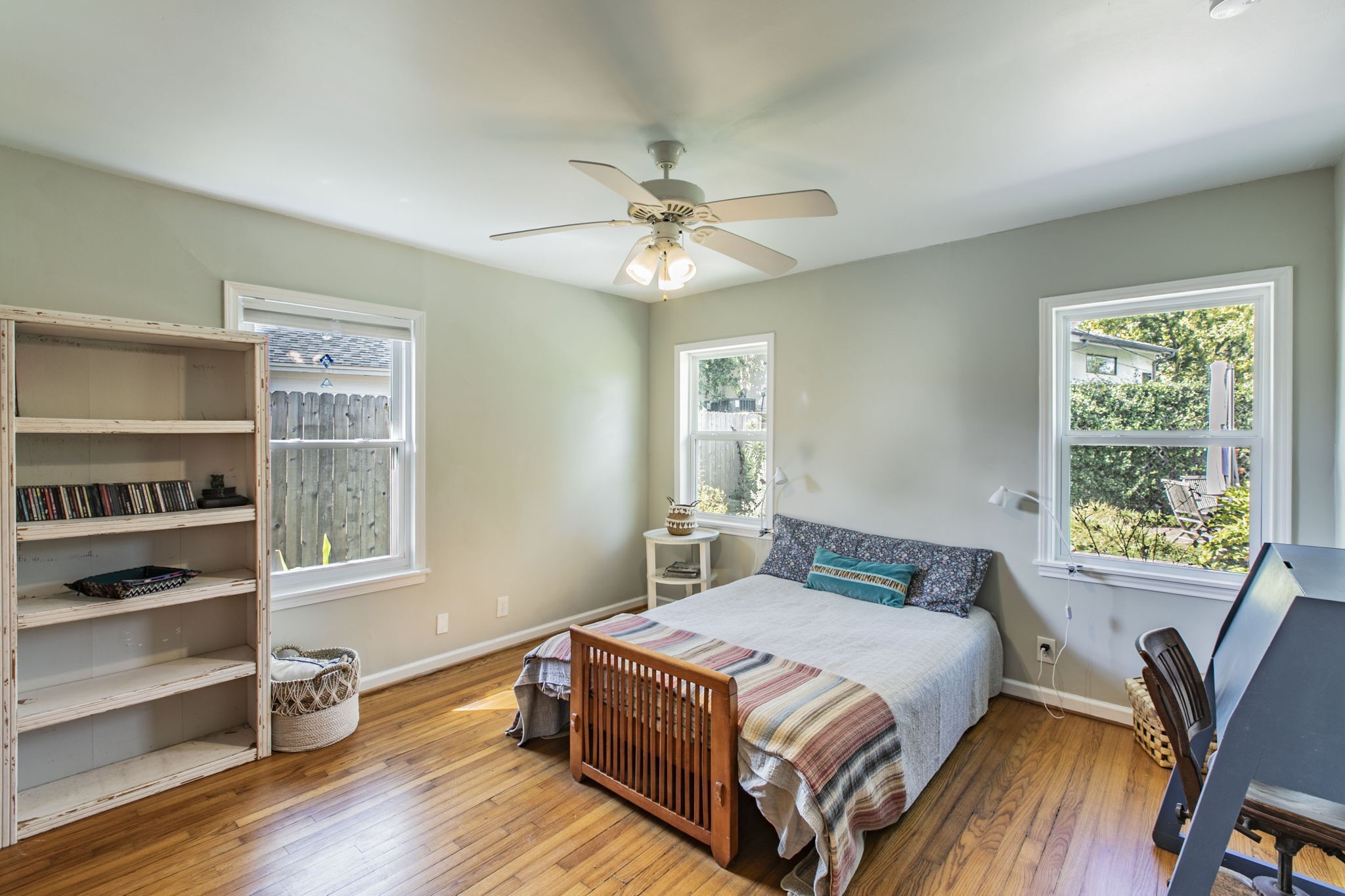 1111 Woodhill Road Houston, TX 77008 - Photo 15 of 42 a bedroom with a bed and wooden floor