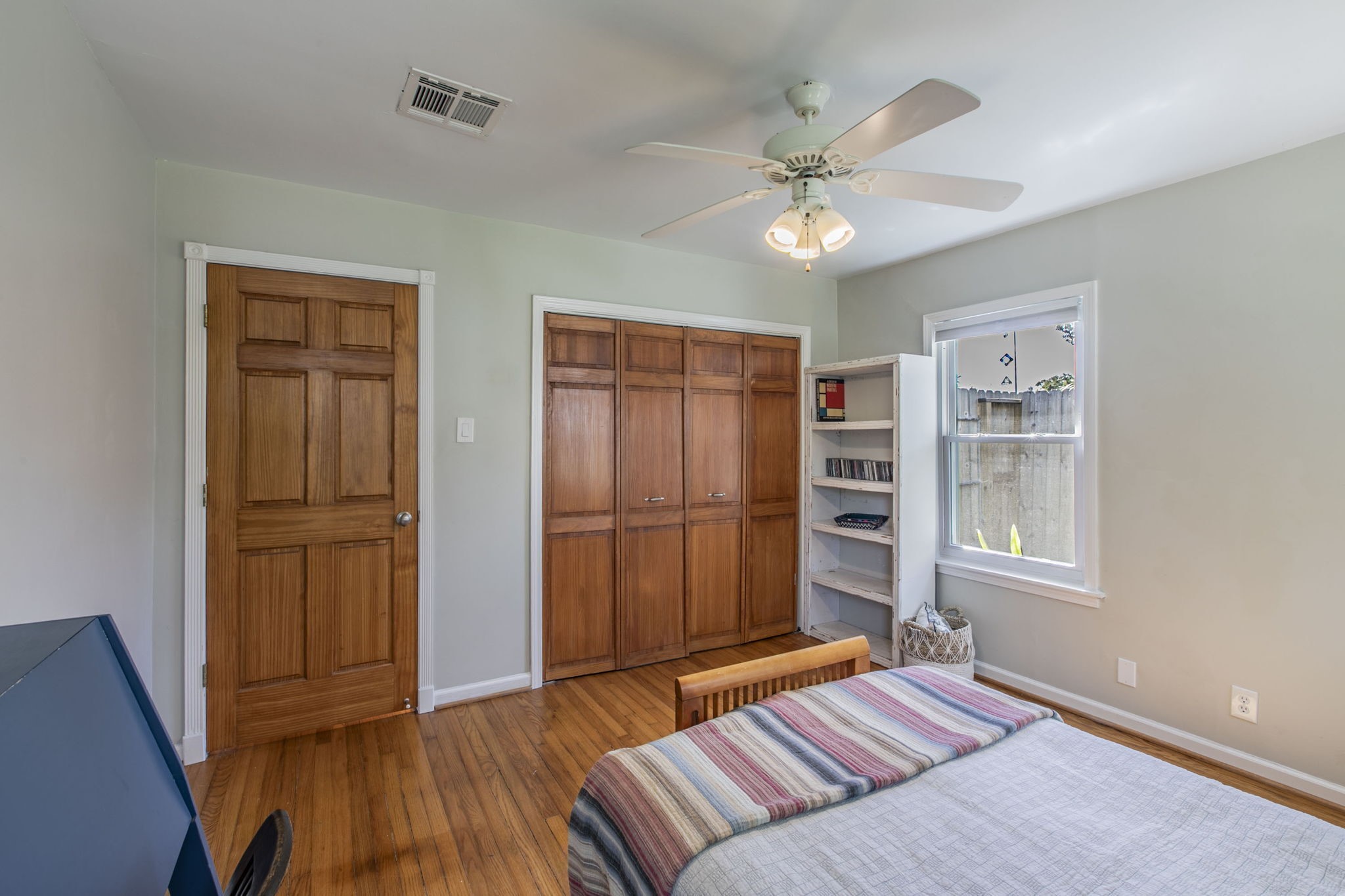 1111 Woodhill Road Houston, TX 77008 - Photo 16 of 42 a bedroom with a bed and wooden floor