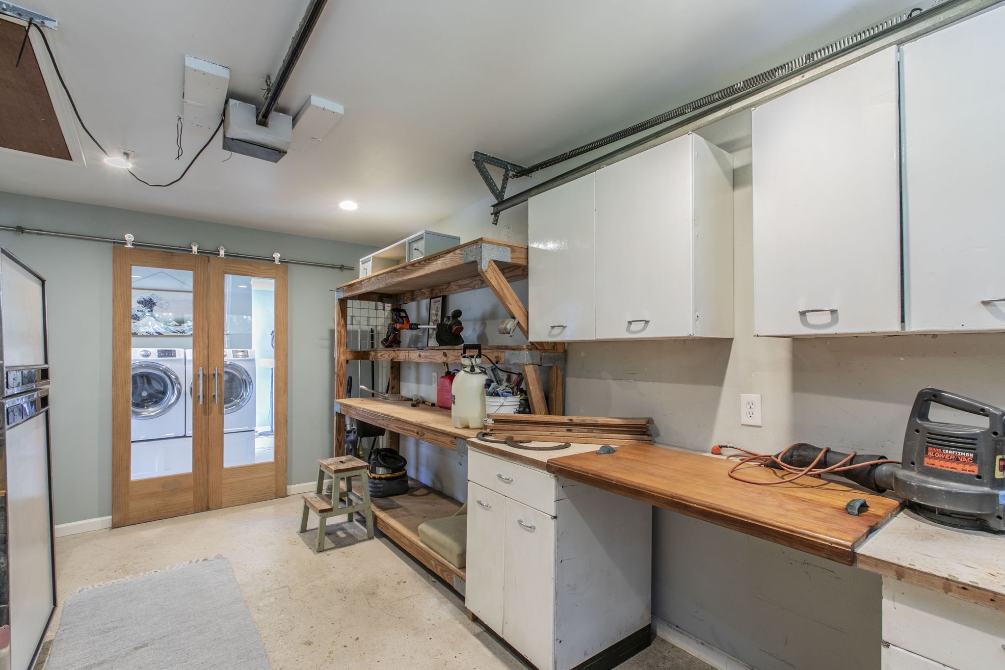 1111 Woodhill Road Houston, TX 77008 - Photo 21 of 42 a room with stainless steel appliances kitchen island granite countertop a refrigerator and wooden cabinets
