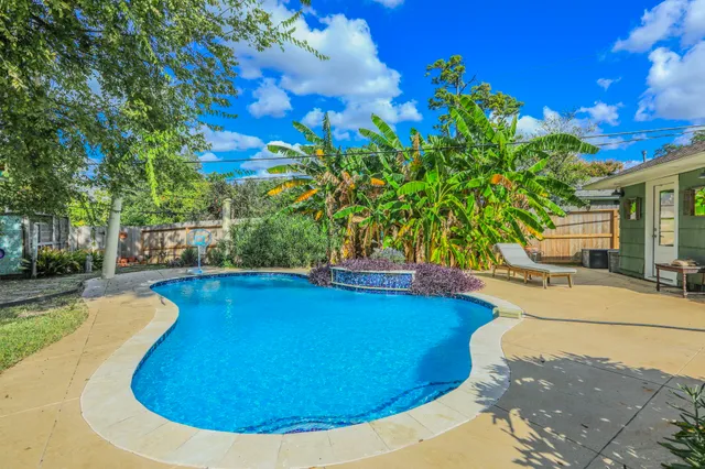 a view of a swimming pool with an outdoor space and seating area