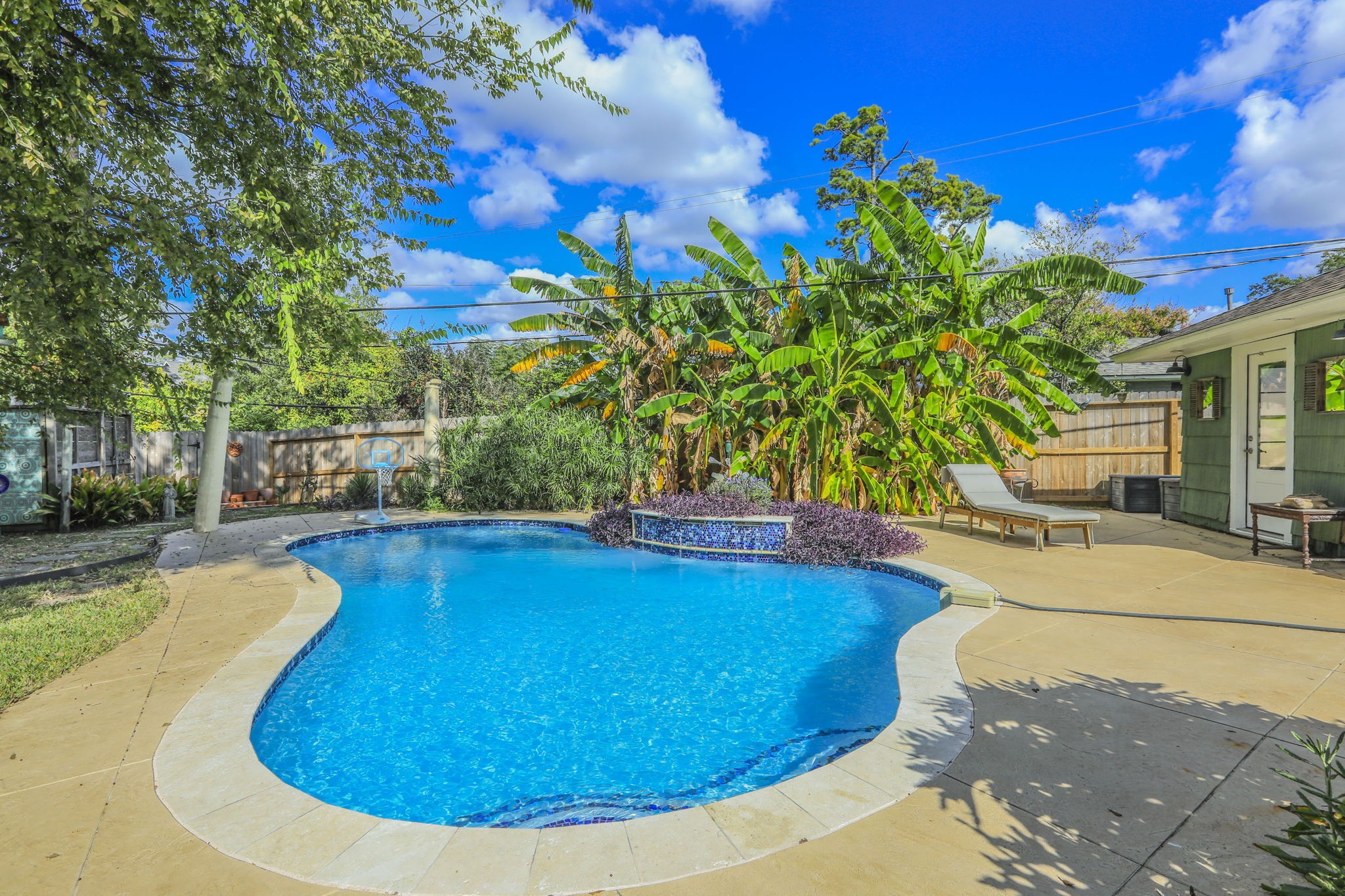 1111 Woodhill Road Houston, TX 77008 - Photo 23 of 42 a view of a swimming pool with an outdoor space and seating area