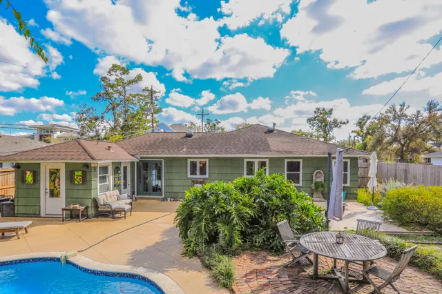 a backyard of a house with table and chairs