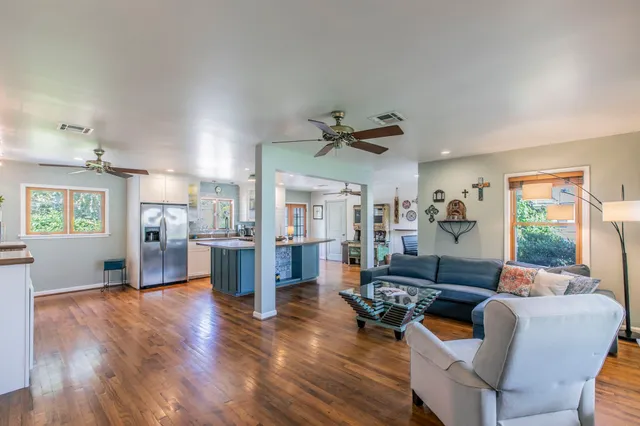 a living room with fireplace furniture and a wooden floor