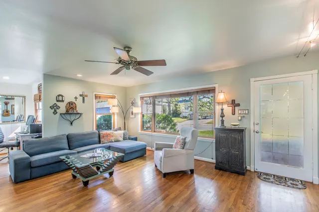 a living room with furniture and a wooden floor