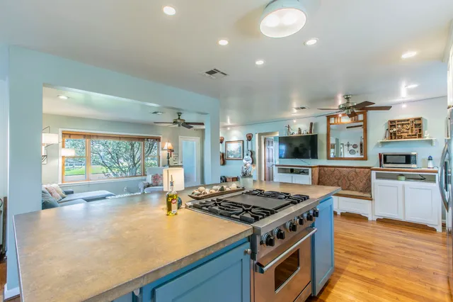 a kitchen with stainless steel appliances granite countertop a stove and a sink