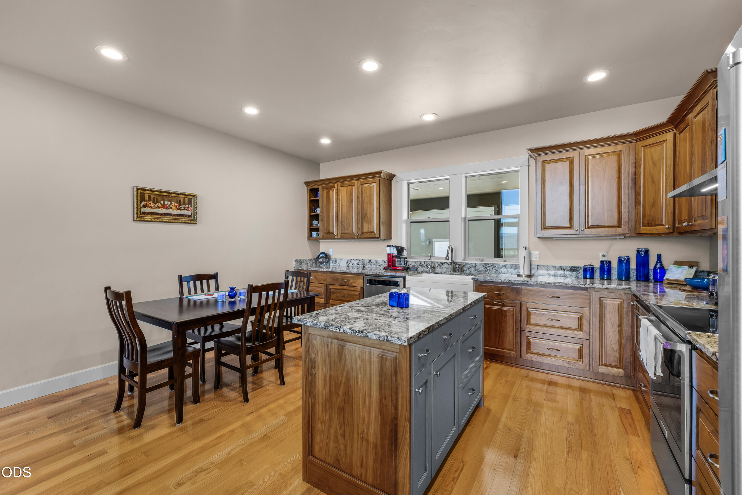 26216 West Bench Road John Day, OR 97845 - Photo 17 of 53 a kitchen with stainless steel appliances granite countertop a stove top oven a sink dishwasher a dining table and chairs with wooden floor