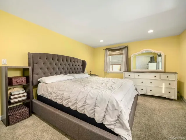 a bedroom with a bed and a dresser