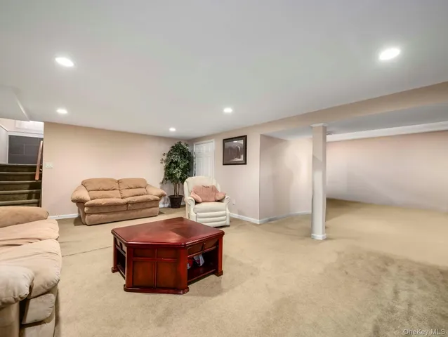 a living room with couches and kitchen view