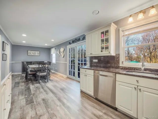 a kitchen with stainless steel appliances granite countertop a stove and a wooden floors