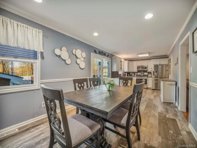 a view of a dining room with furniture and wooden floor