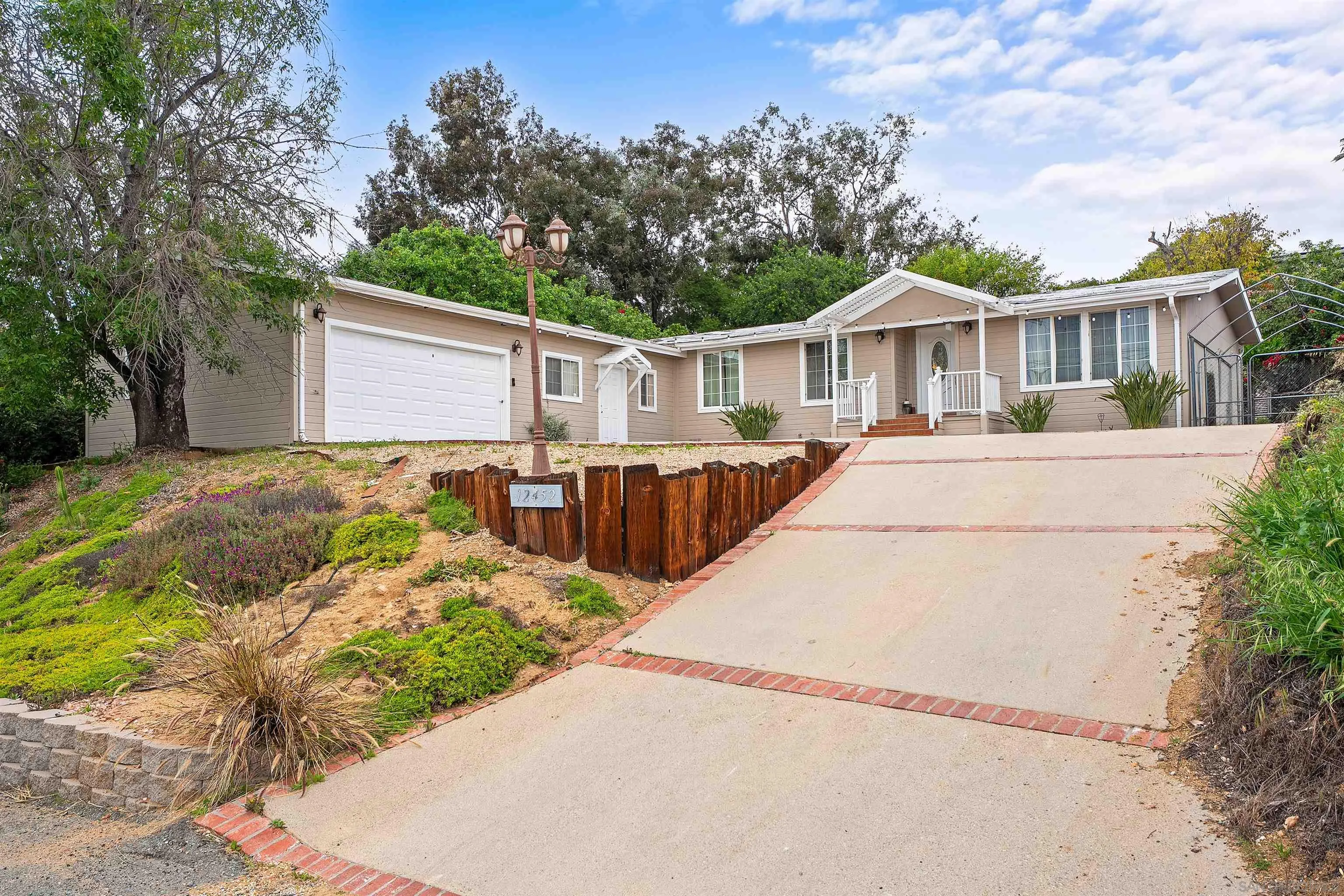 12452 Janet Kay Way El Cajon, CA 92021 - Photo 29 of 30 a front view of a house with a yard and potted plants