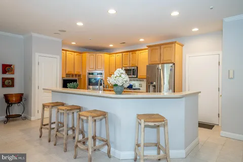 a kitchen with a table chairs sink and cabinets