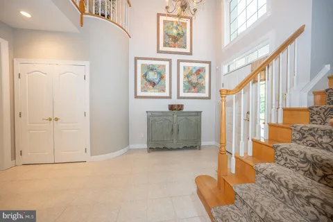a living room with furniture a flat screen tv and a large window