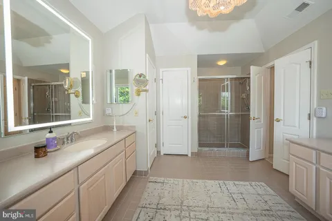 a bathroom with a double vanity sink and mirror