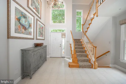 a view of entryway with furniture and stairs
