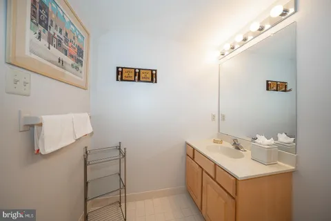 a bathroom with a sink mirror and vanity