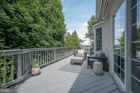 a view of roof deck with chairs and wooden floor
