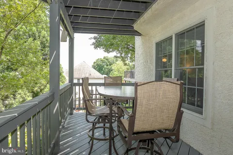 a view of a chair and table in the balcony