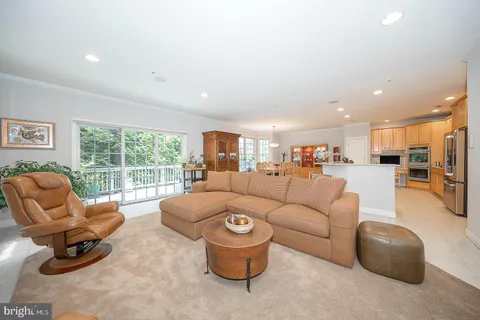 a living room with furniture a table and a large window