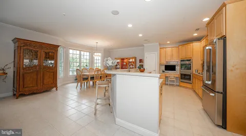 a kitchen with a refrigerator and a dining table
