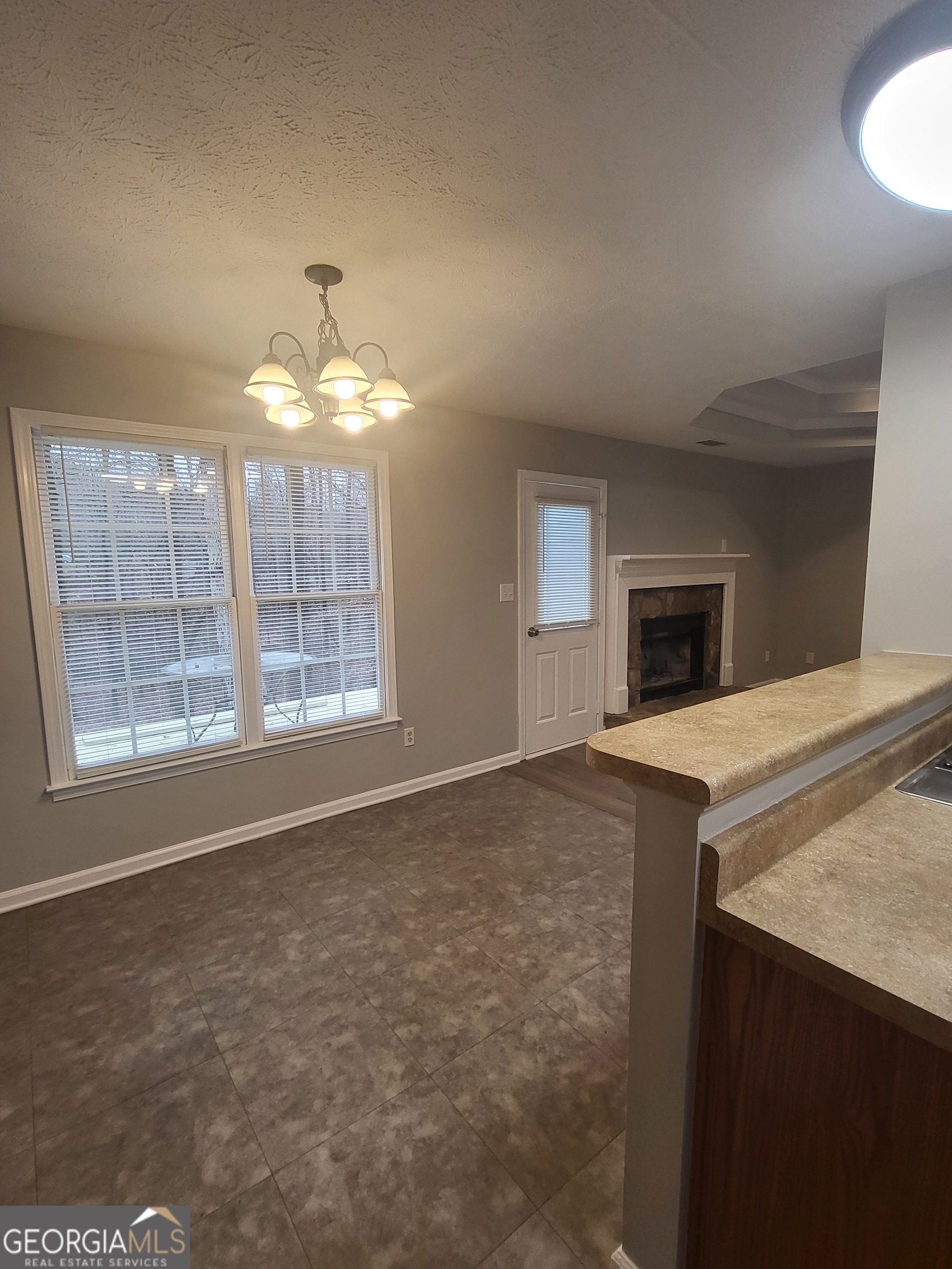 112 Sundown Drive Dawsonville, GA 30534 - Photo 11 of 25 a view of an empty room with window and chandelier